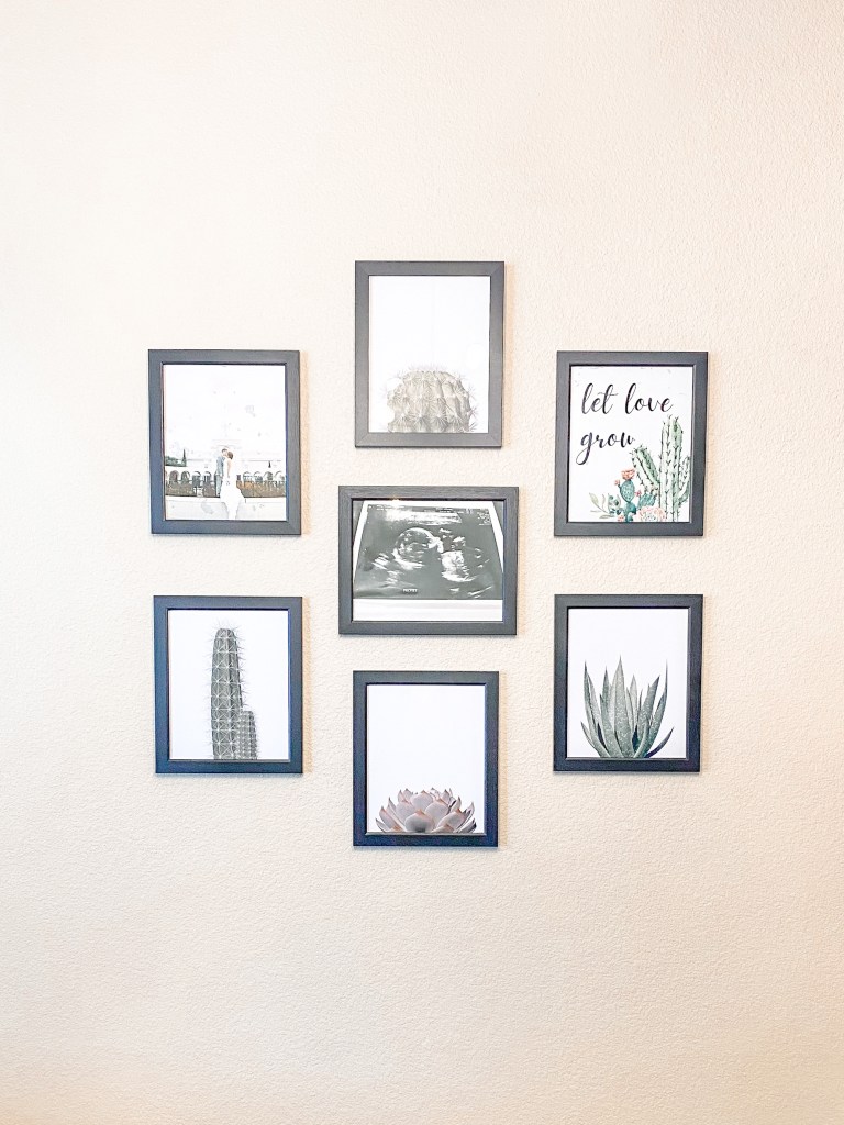 a wall collage with cacti and succulent prints with one reading "let love grow"