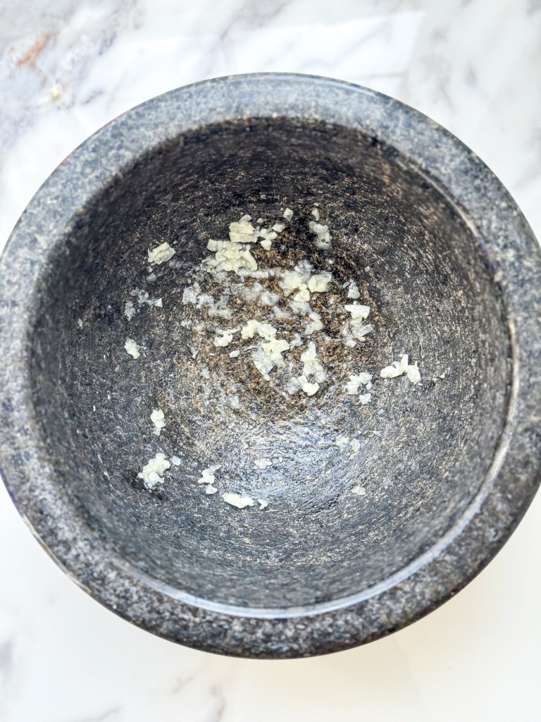 fresh minced garlic in a mortar
